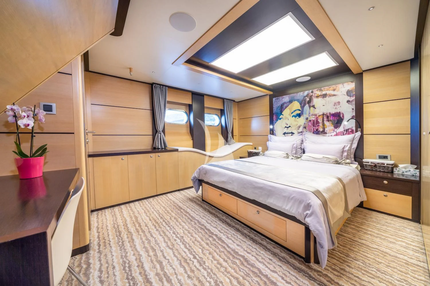 a bedroom with a bed and a desk aboard NAVILUX Yacht for Sale