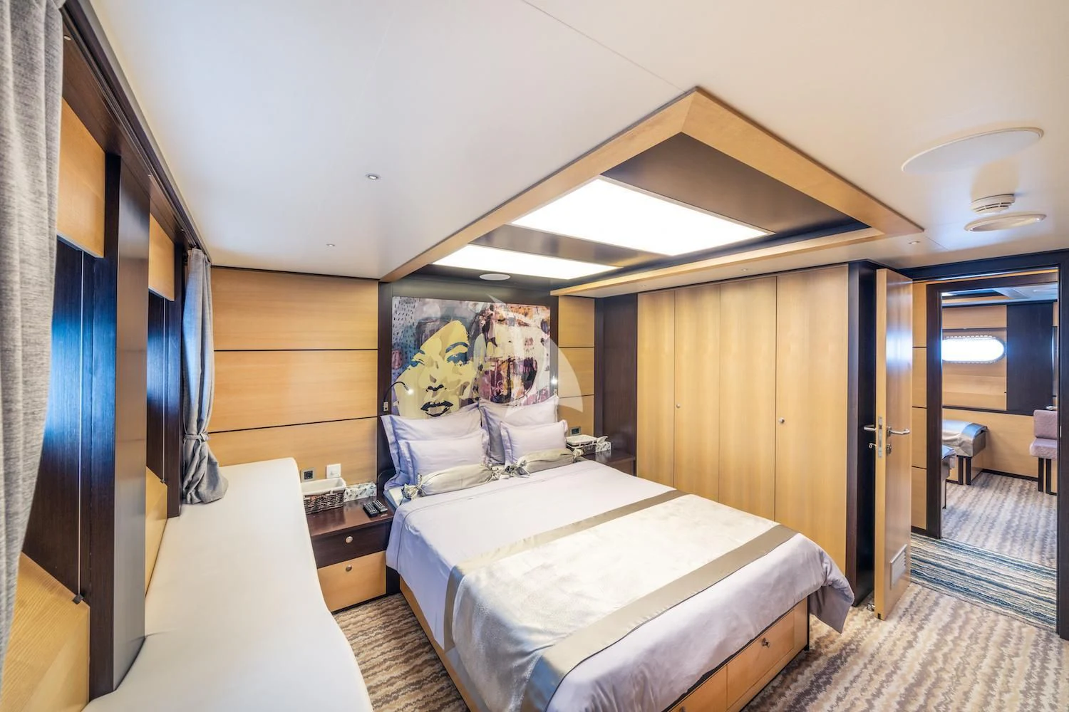a bedroom with a bed and a mirror aboard NAVILUX Yacht for Sale