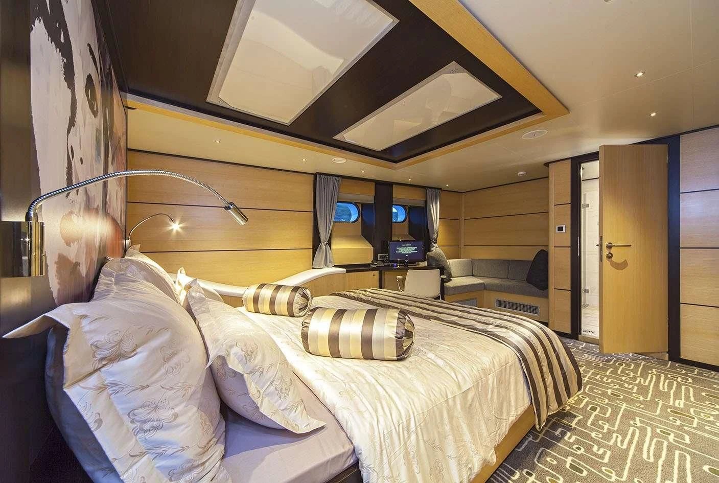 a room with a bed and a tv aboard NAVILUX Yacht for Sale