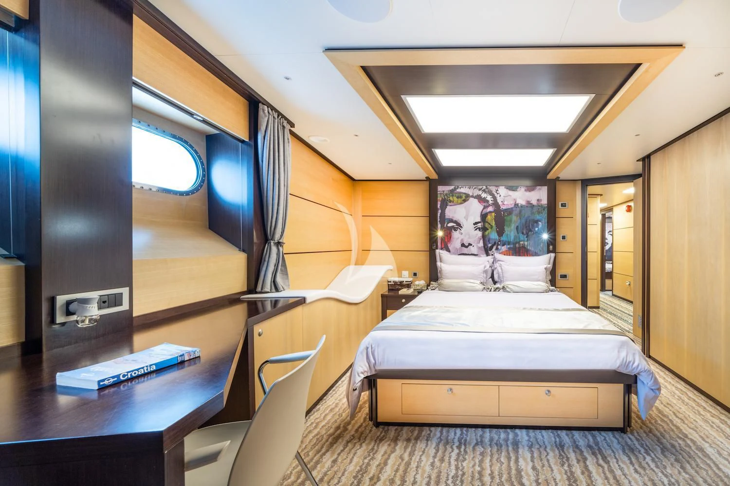 a room with a bed and a desk aboard NAVILUX Yacht for Sale