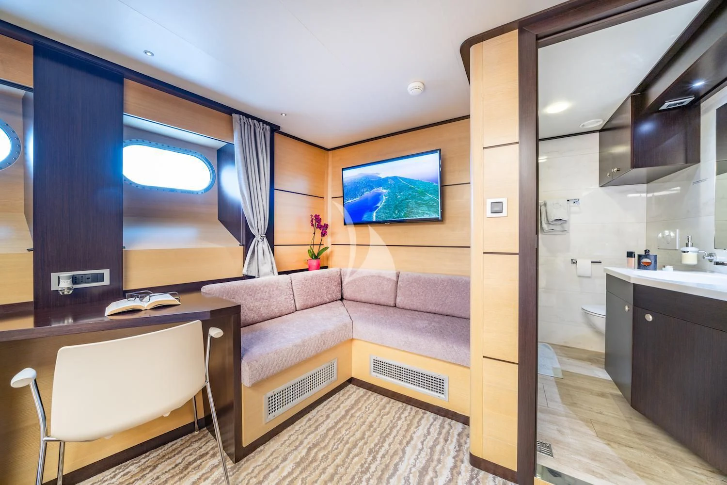 a living room with a couch and a tv aboard NAVILUX Yacht for Sale