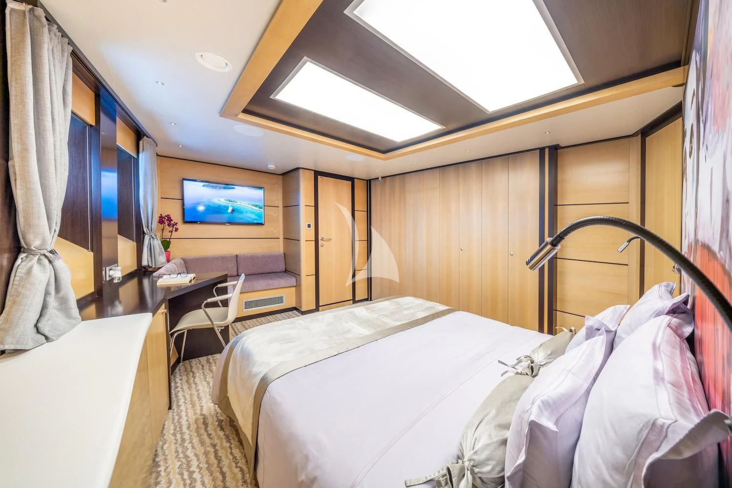 a room with a bed and a tv aboard NAVILUX Yacht for Sale