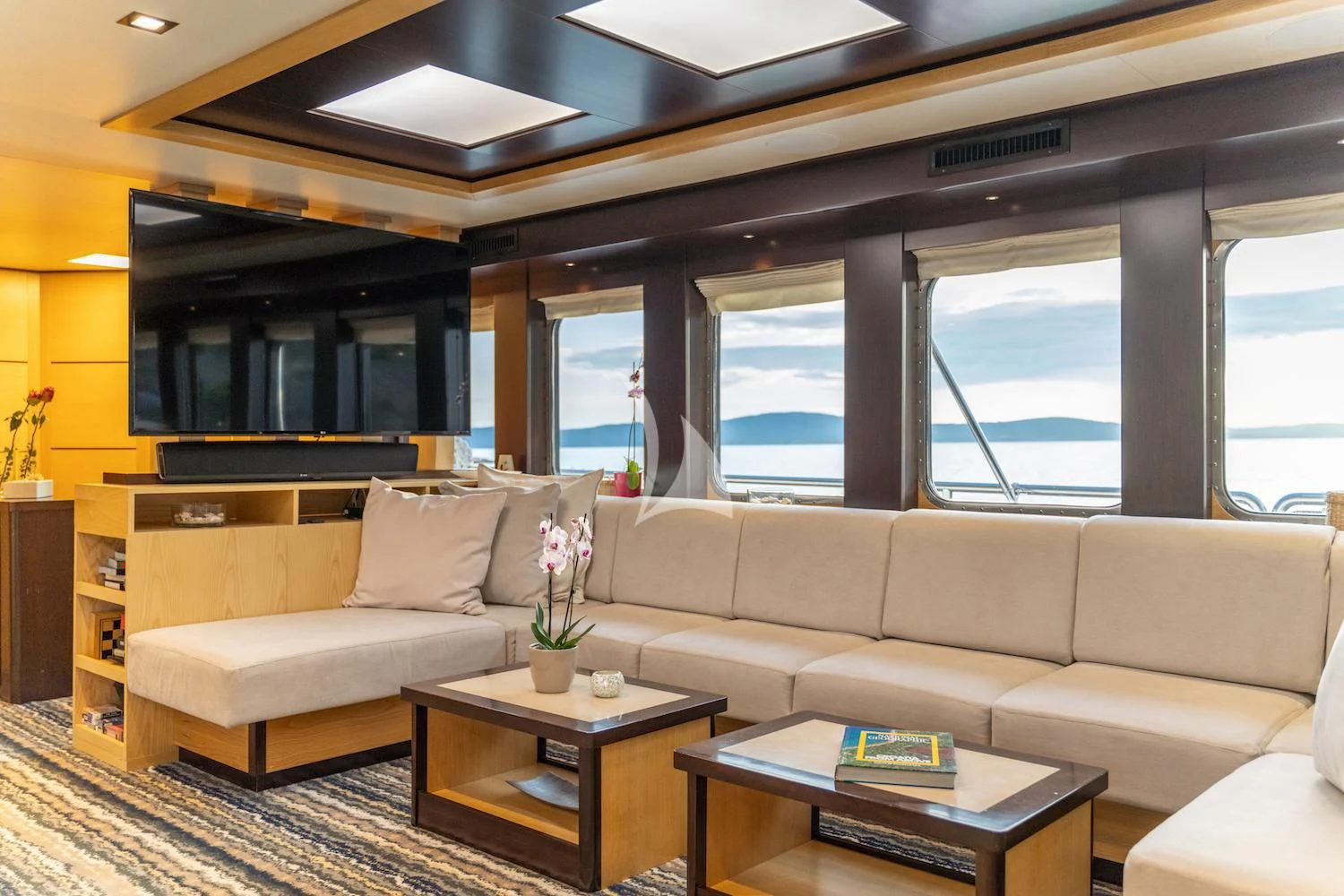 a living room with a couch and coffee table aboard NAVILUX Yacht for Sale
