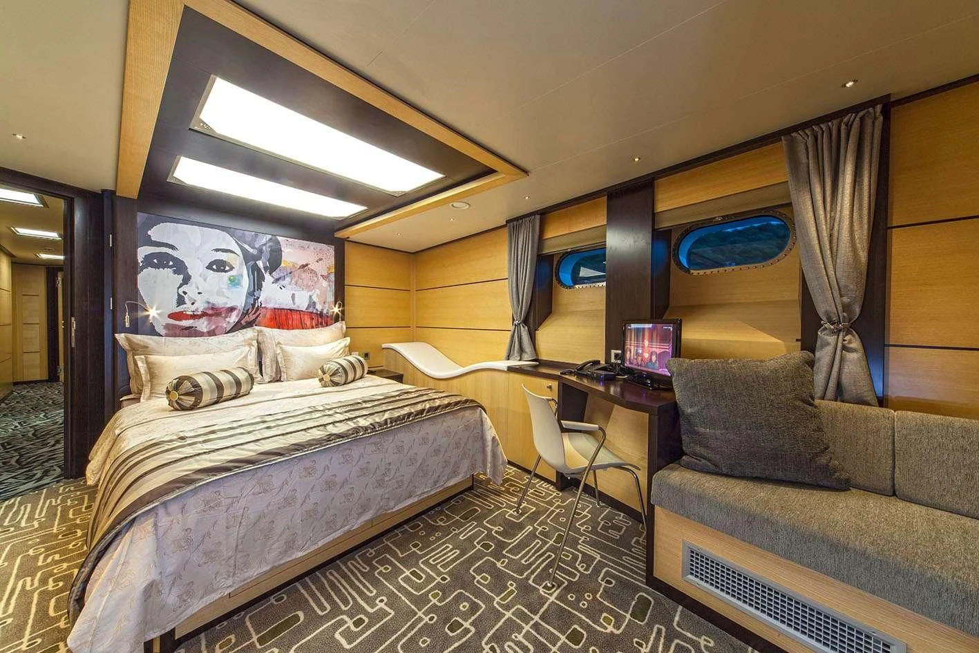a bedroom with a bed and a couch aboard NAVILUX Yacht for Sale
