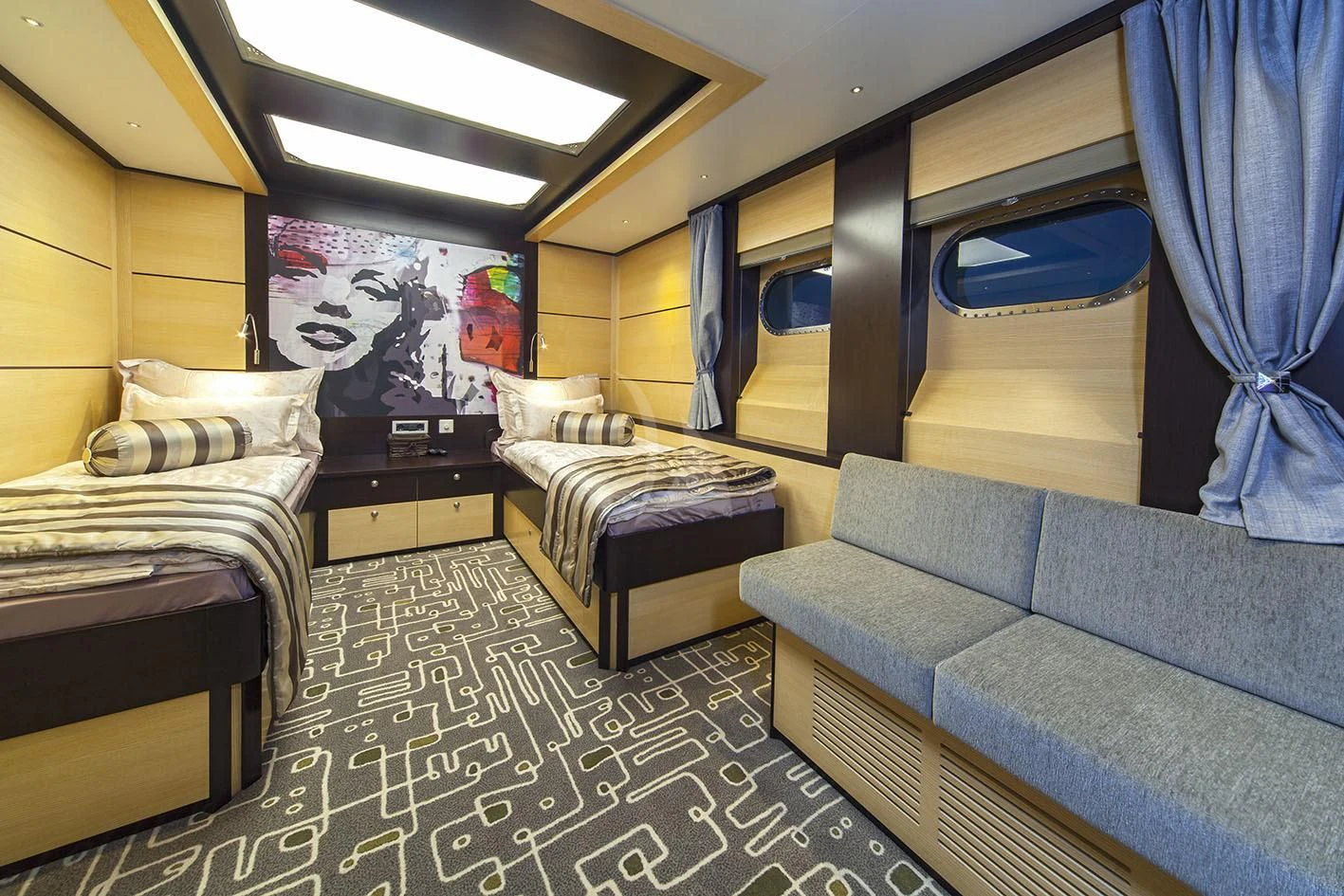 a room with a bed and a couch aboard NAVILUX Yacht for Sale