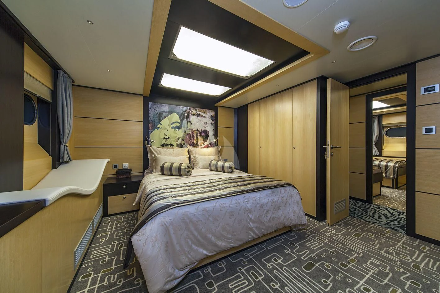a room with a bed and a desk aboard NAVILUX Yacht for Sale