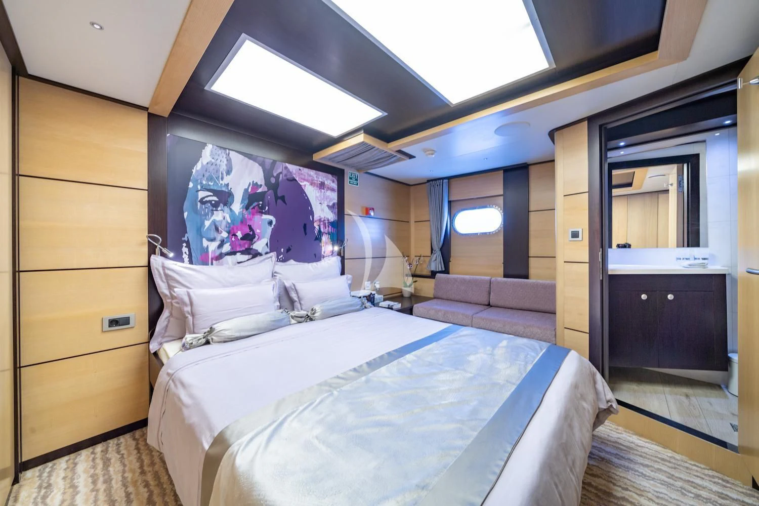 a room with a bed and a couch aboard NAVILUX Yacht for Sale
