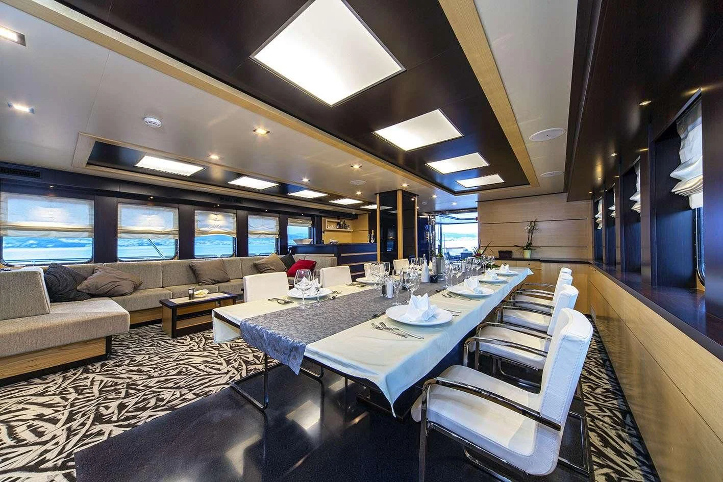 a room with a table and chairs aboard NAVILUX Yacht for Sale