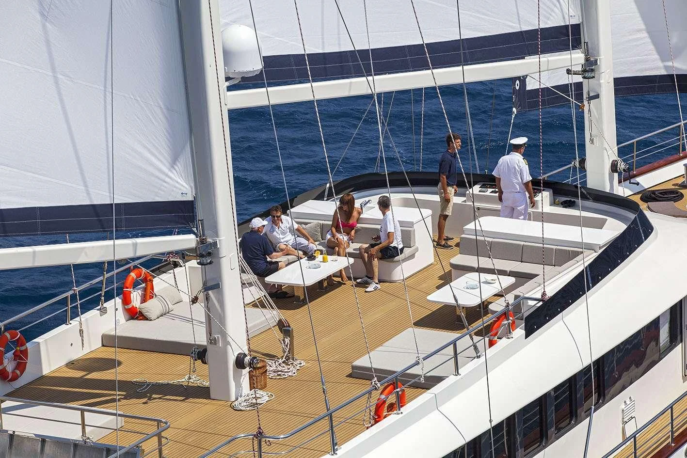 people sitting on a white boat aboard NAVILUX Yacht for Sale