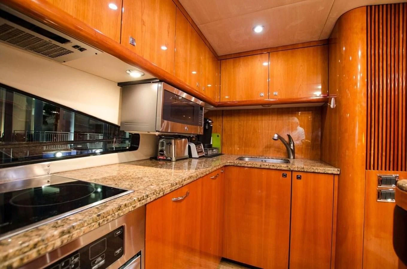 a kitchen with wooden cabinets aboard SAMARA Yacht for Sale