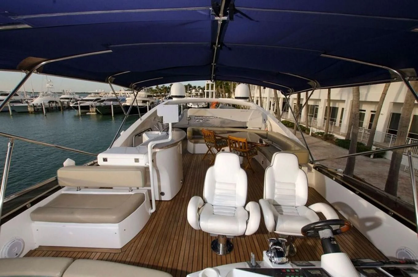 a deck with chairs and a boat on it aboard SAMARA Yacht for Sale