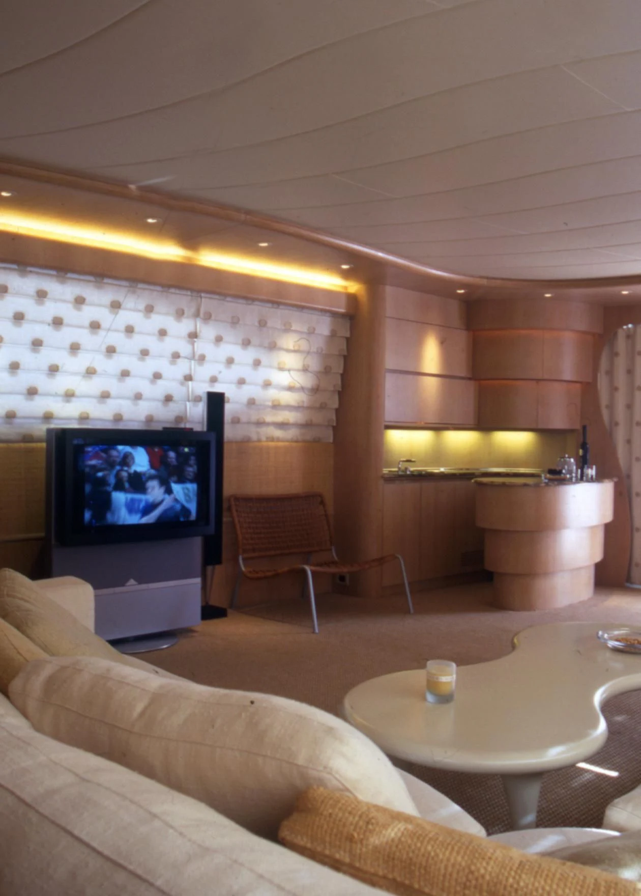 a living room with a tv and a table aboard IF Yacht for Sale