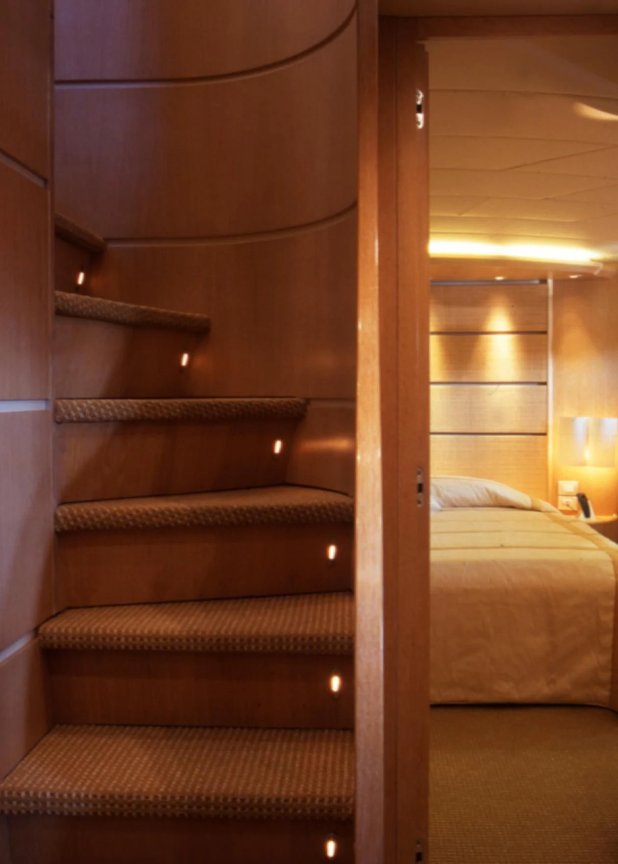 a bed with a wood frame aboard IF Yacht for Sale
