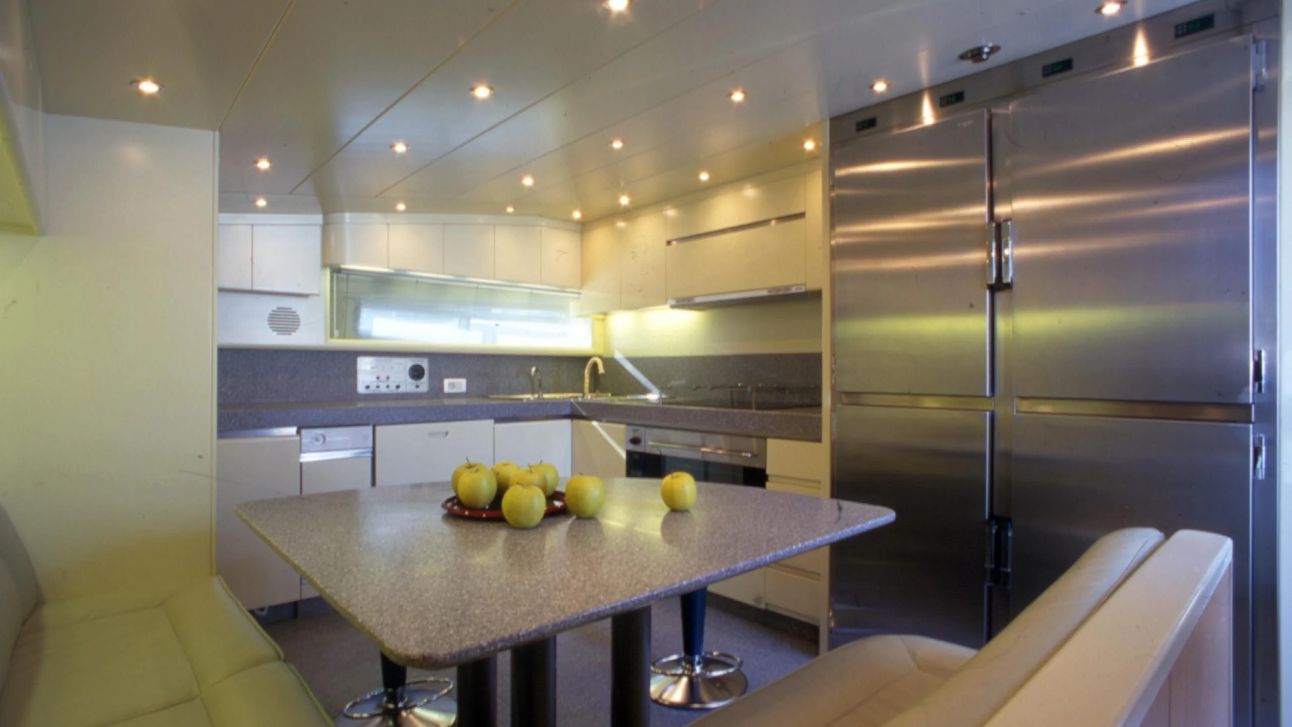 a kitchen with a table and a refrigerator aboard IF Yacht for Sale