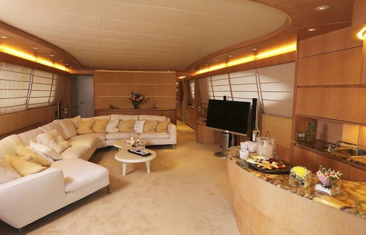 a living room with a large screen aboard IF Yacht for Sale