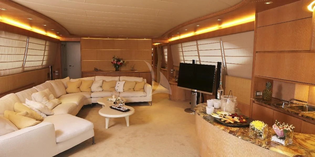 a living room with a large screen aboard IF Yacht for Sale