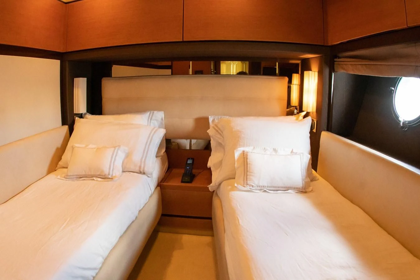 a room with beds and a mirror aboard VA BENE 2011 AZIMUT 70 FLY Yacht for Sale