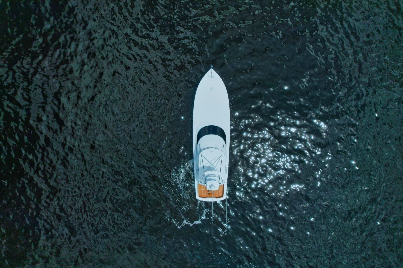 a white surfboard in the water aboard EL LOBO Yacht for Sale