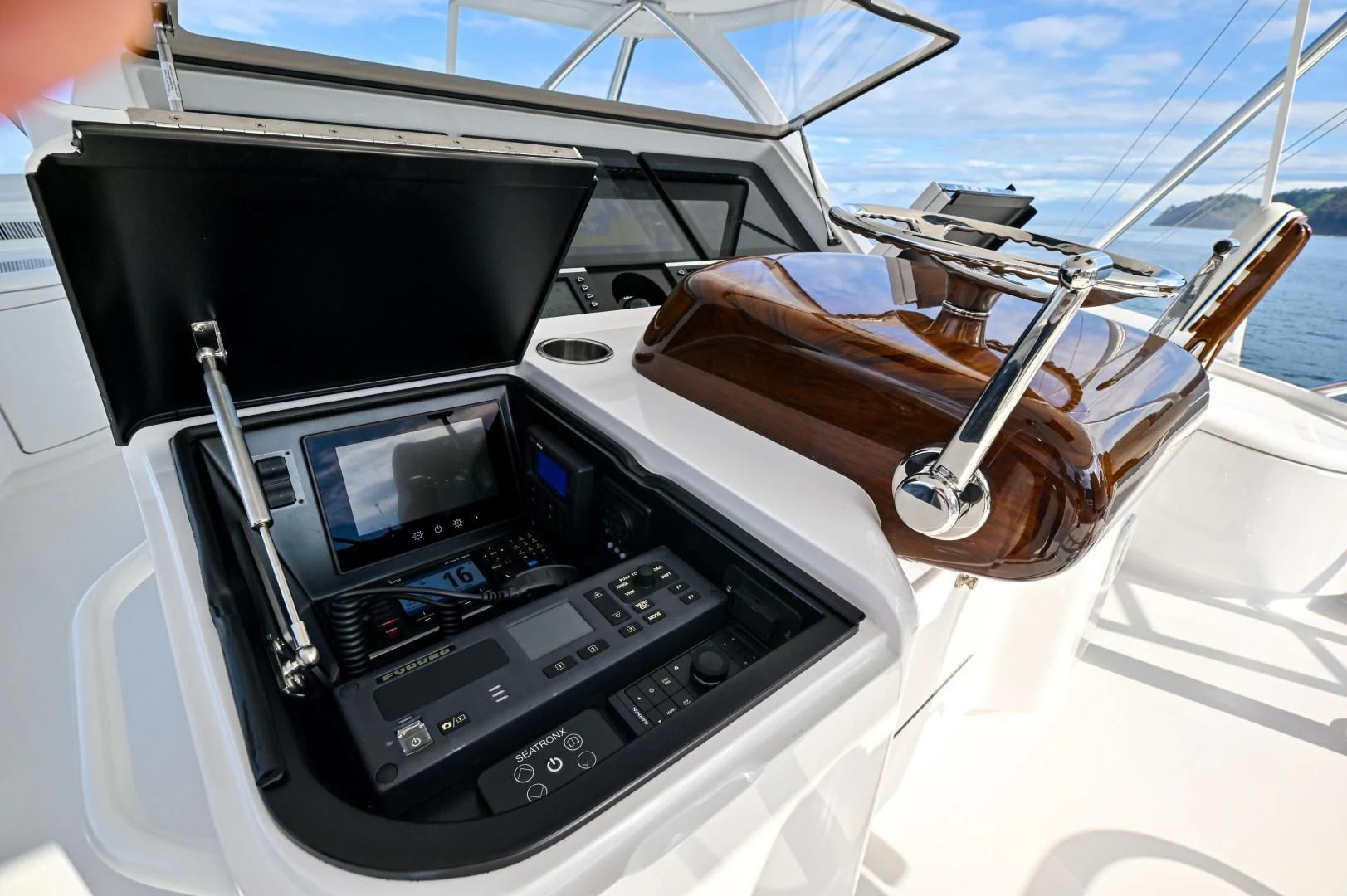a steering wheel and dashboard of a boat aboard EL LOBO Yacht for Sale