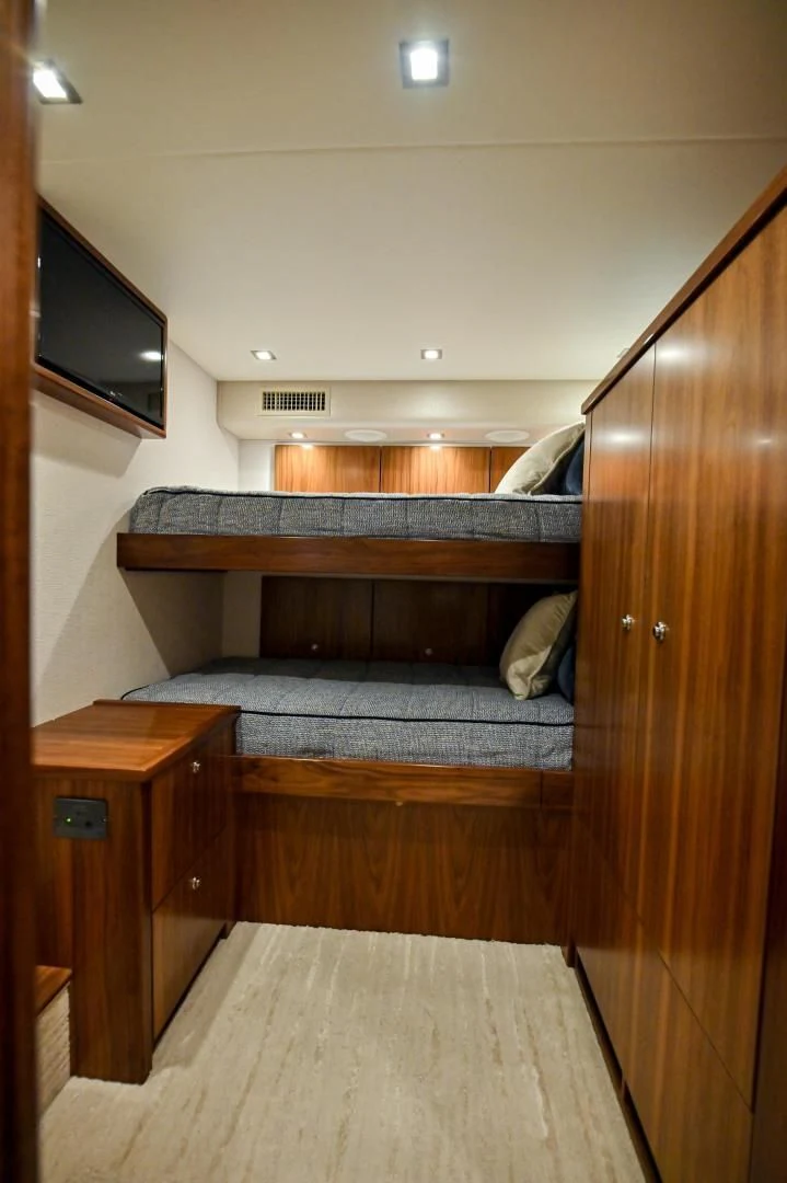 a bed with a television on the wall aboard EL LOBO Yacht for Sale