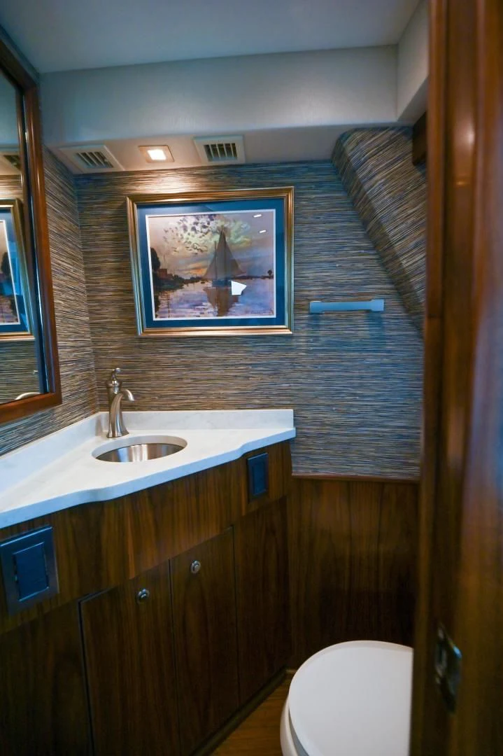 a bathroom with a painting on the wall aboard EL LOBO Yacht for Sale