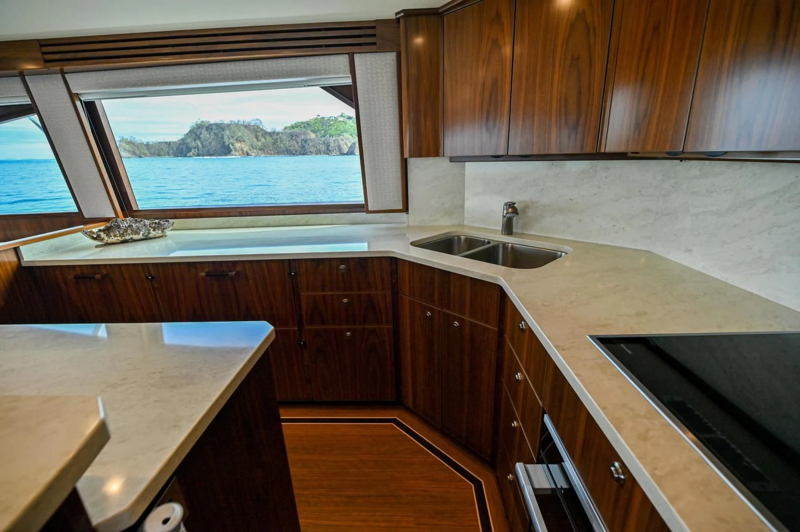 a kitchen with a sink and a window aboard EL LOBO Yacht for Sale