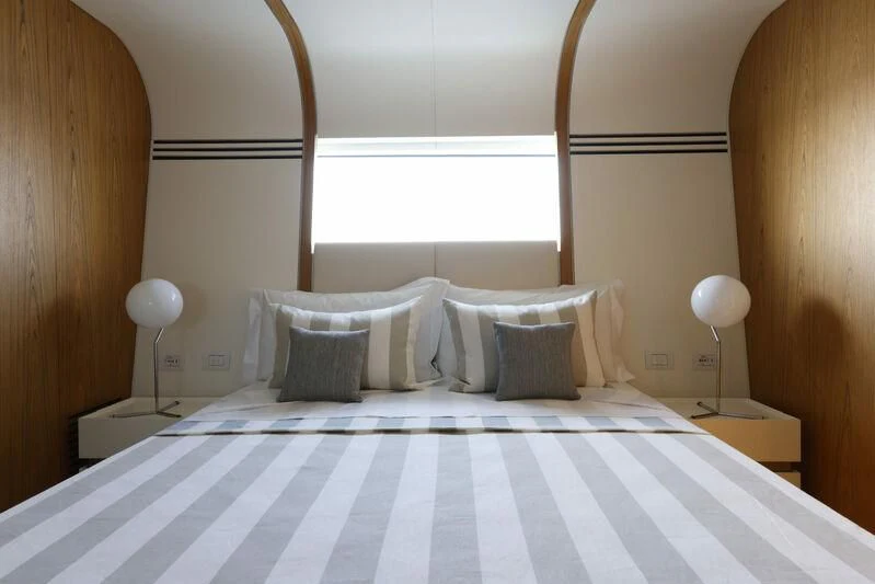 a bed with white sheets aboard EH2 Yacht for Sale