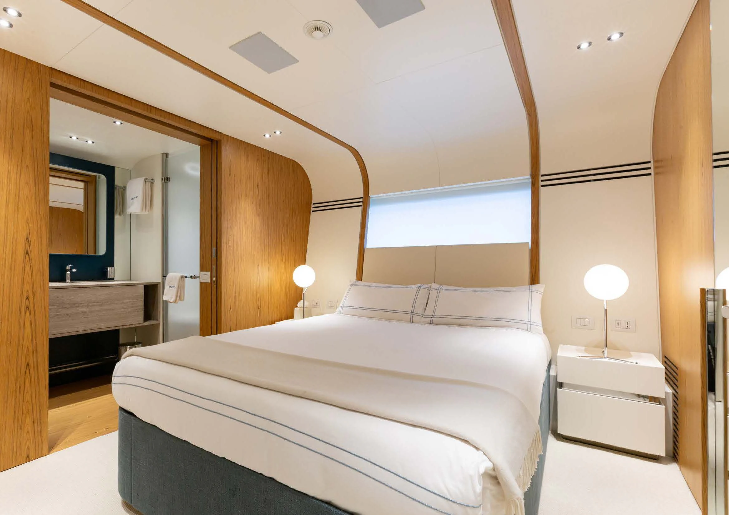 a bedroom with a bed and a mirror aboard EH2 Yacht for Sale