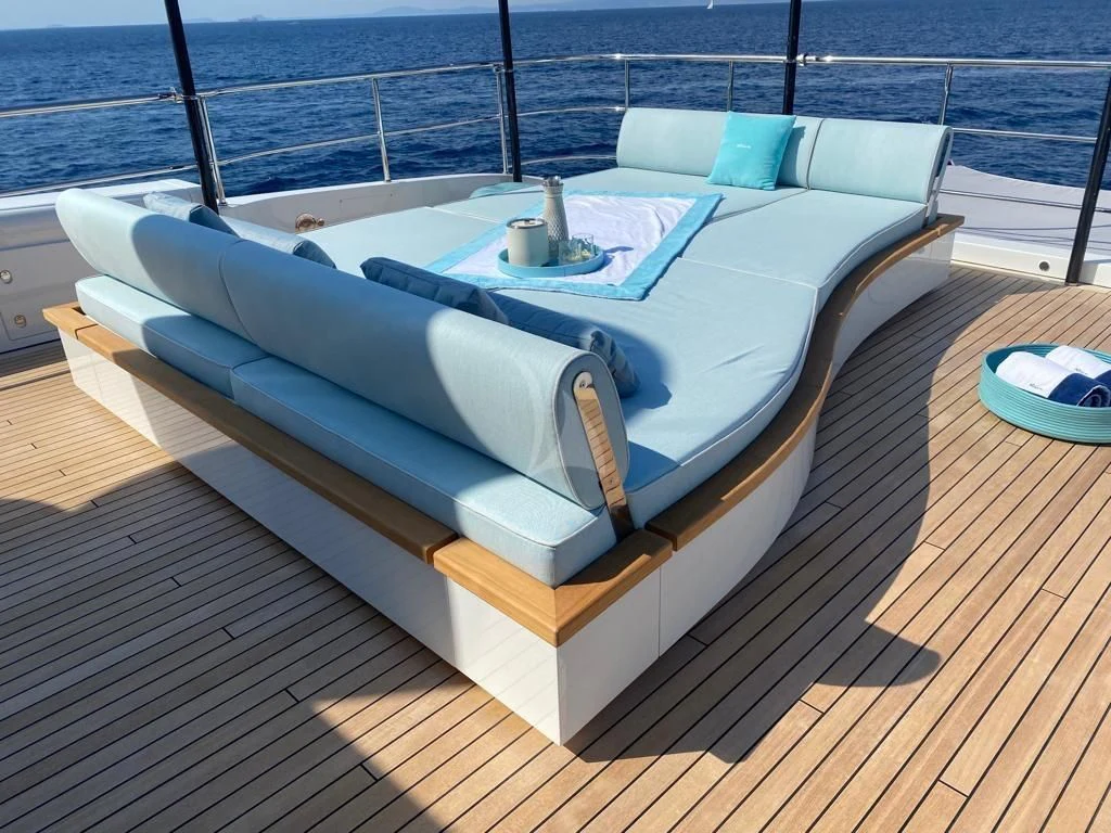 a white lounge chair on a deck aboard EH2 Yacht for Sale