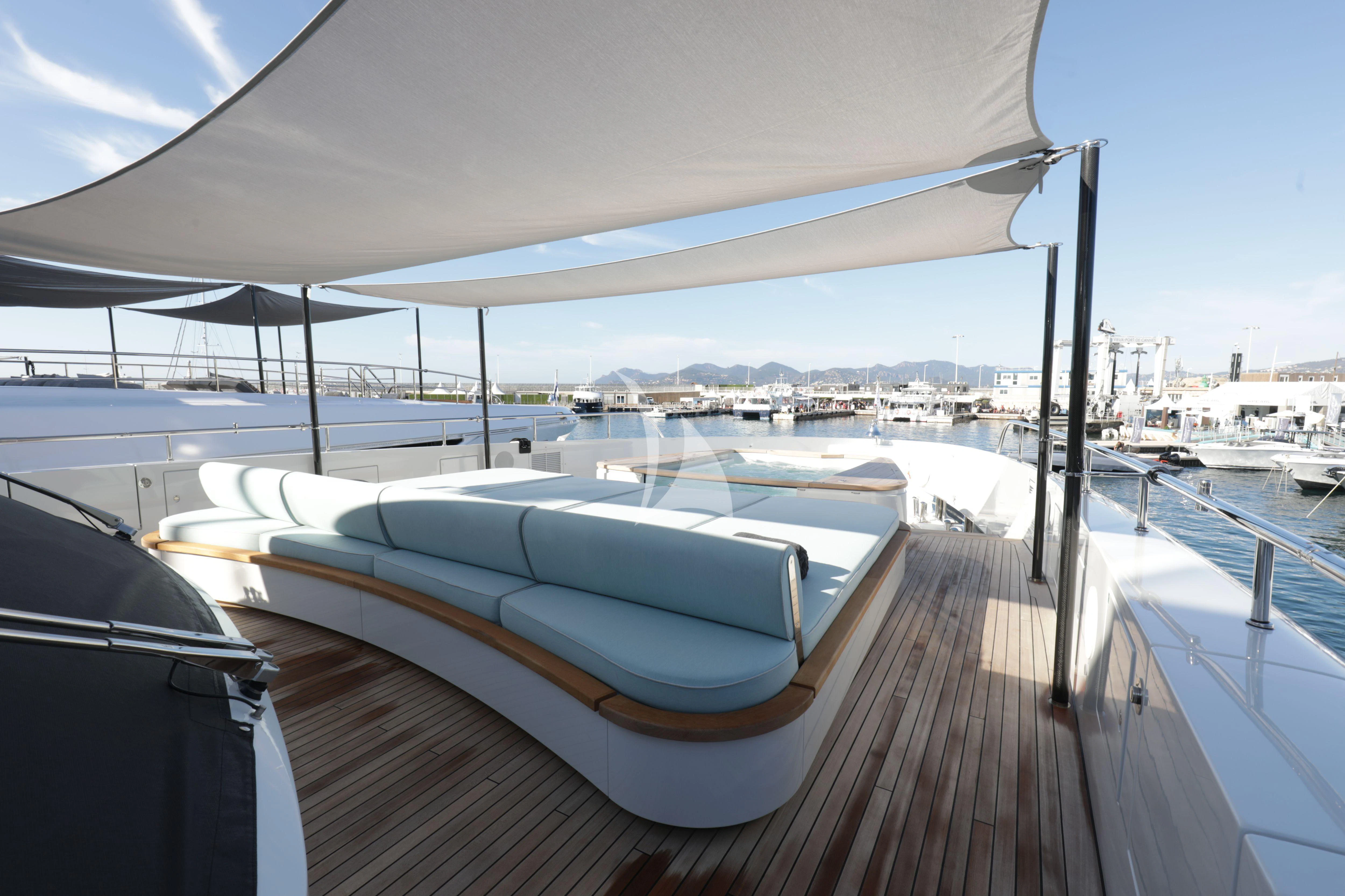 a deck with a boat and umbrella aboard EH2 Yacht for Sale
