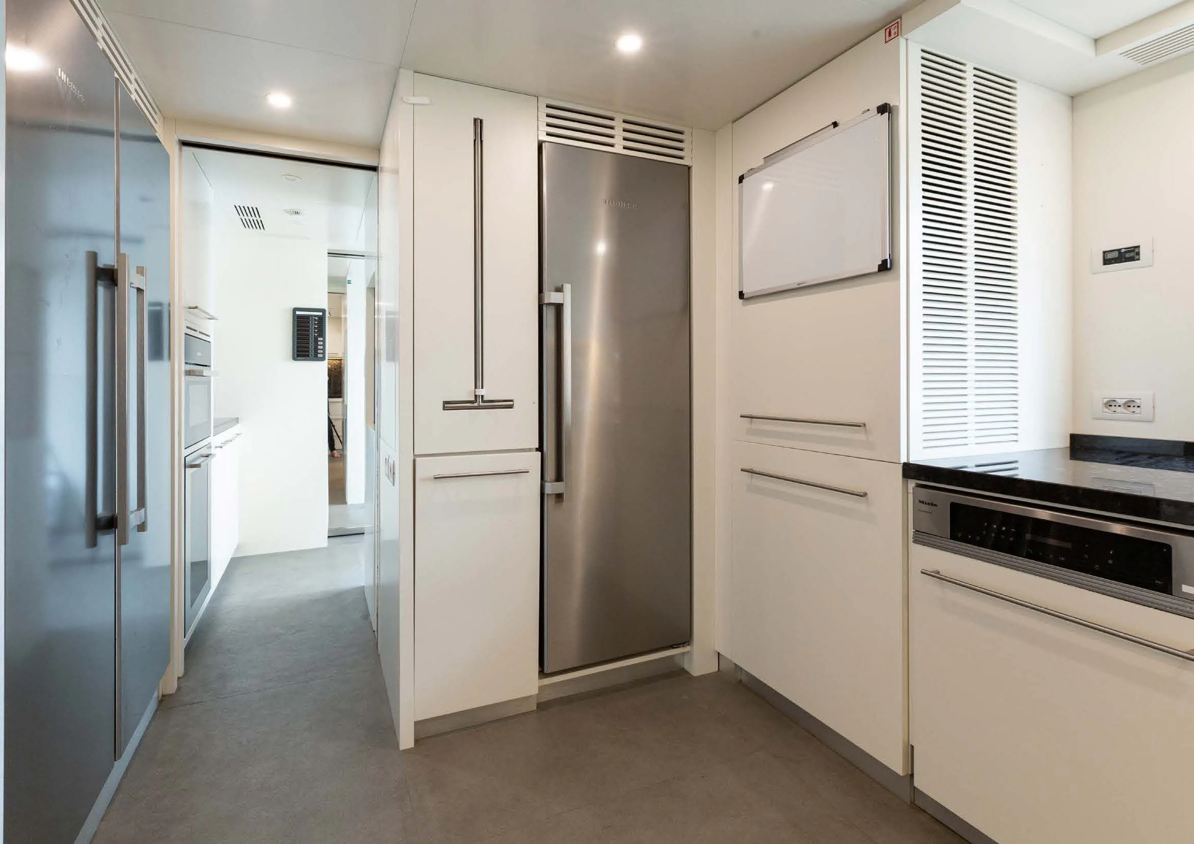 a kitchen with refrigerators and cabinets aboard EH2 Yacht for Sale