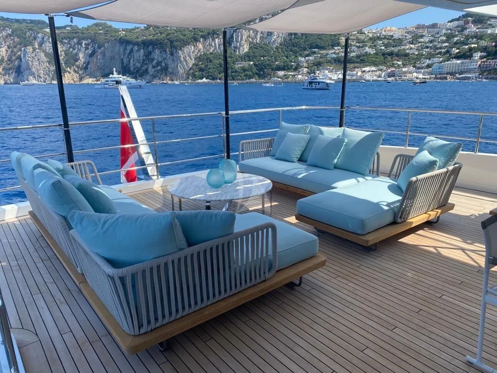 a lounge area with a table and chairs on it aboard EH2 Yacht for Sale
