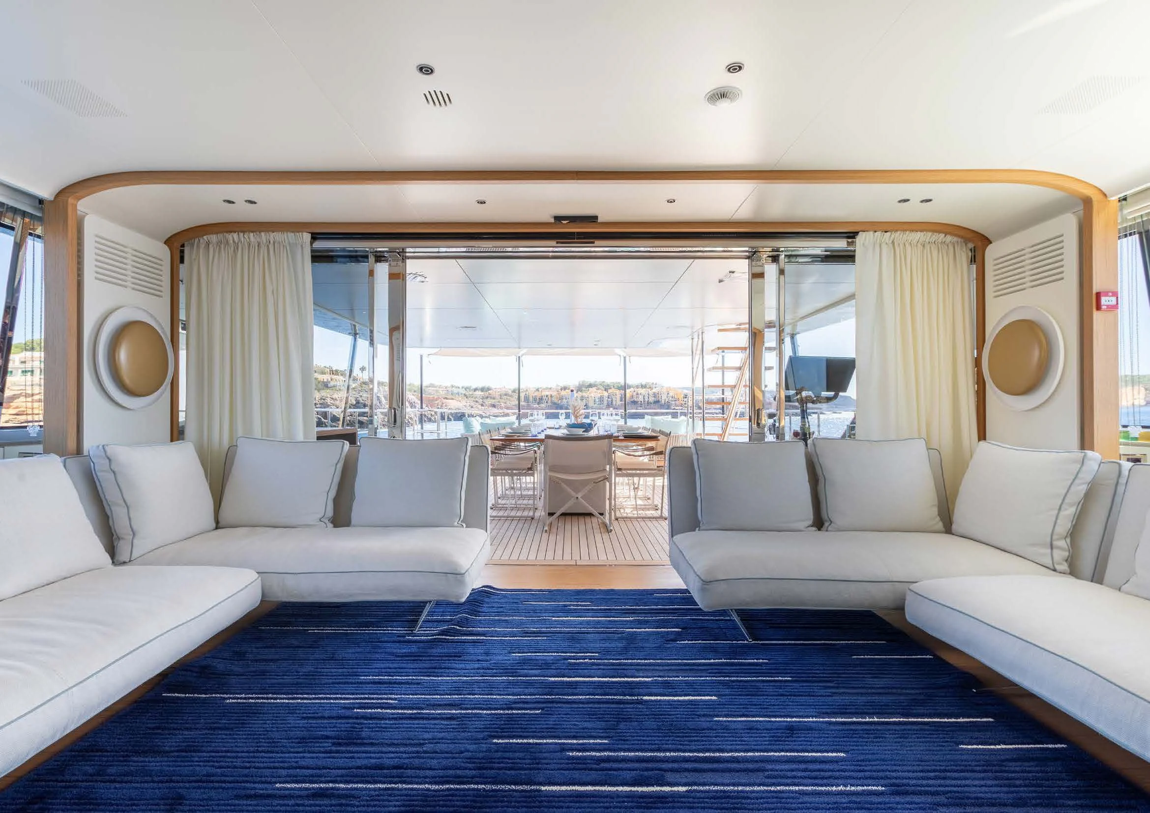 a living room with a large balcony aboard EH2 Yacht for Sale