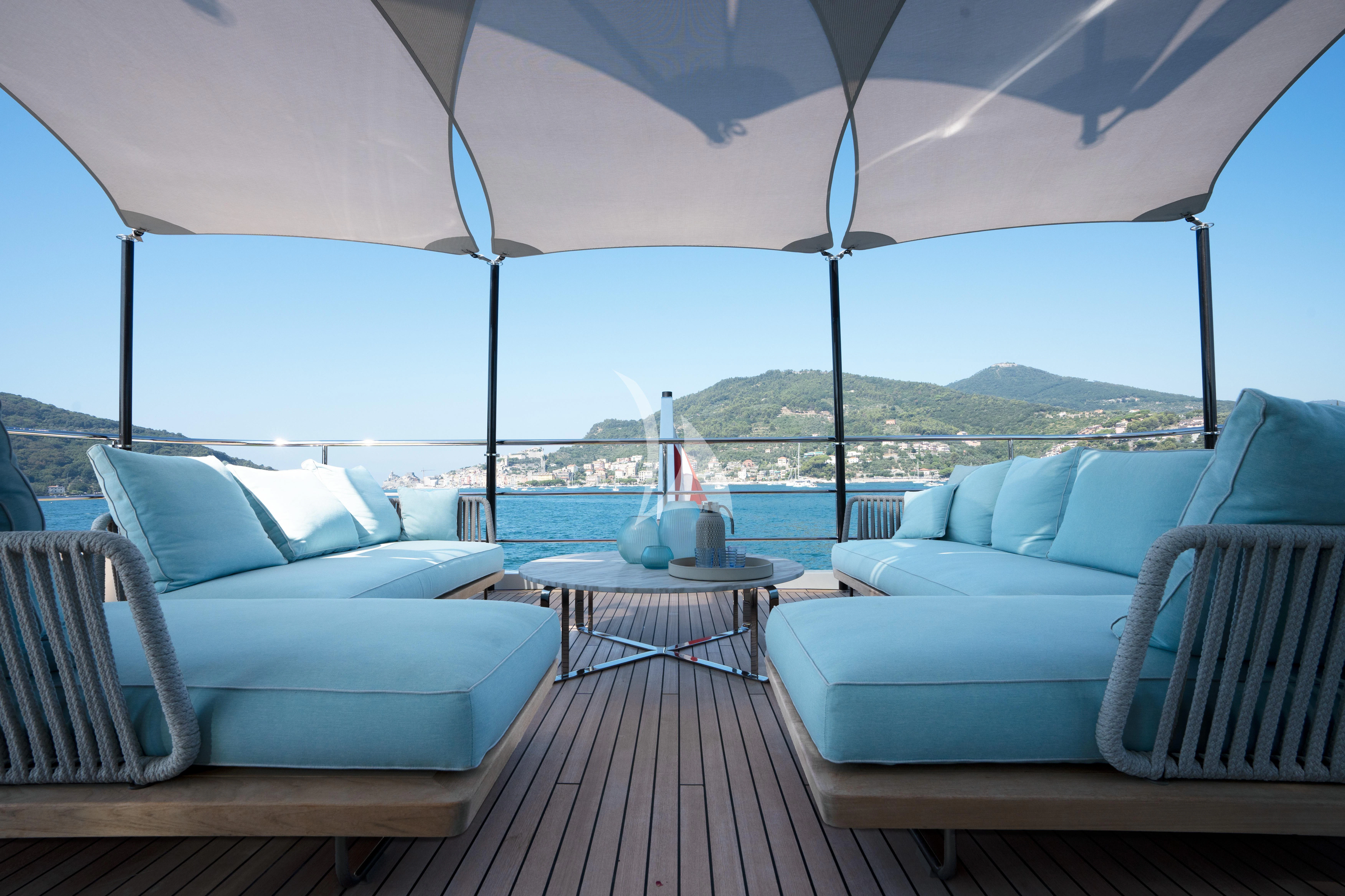 a deck with a view of the water and a boat in the background aboard EH2 Yacht for Sale
