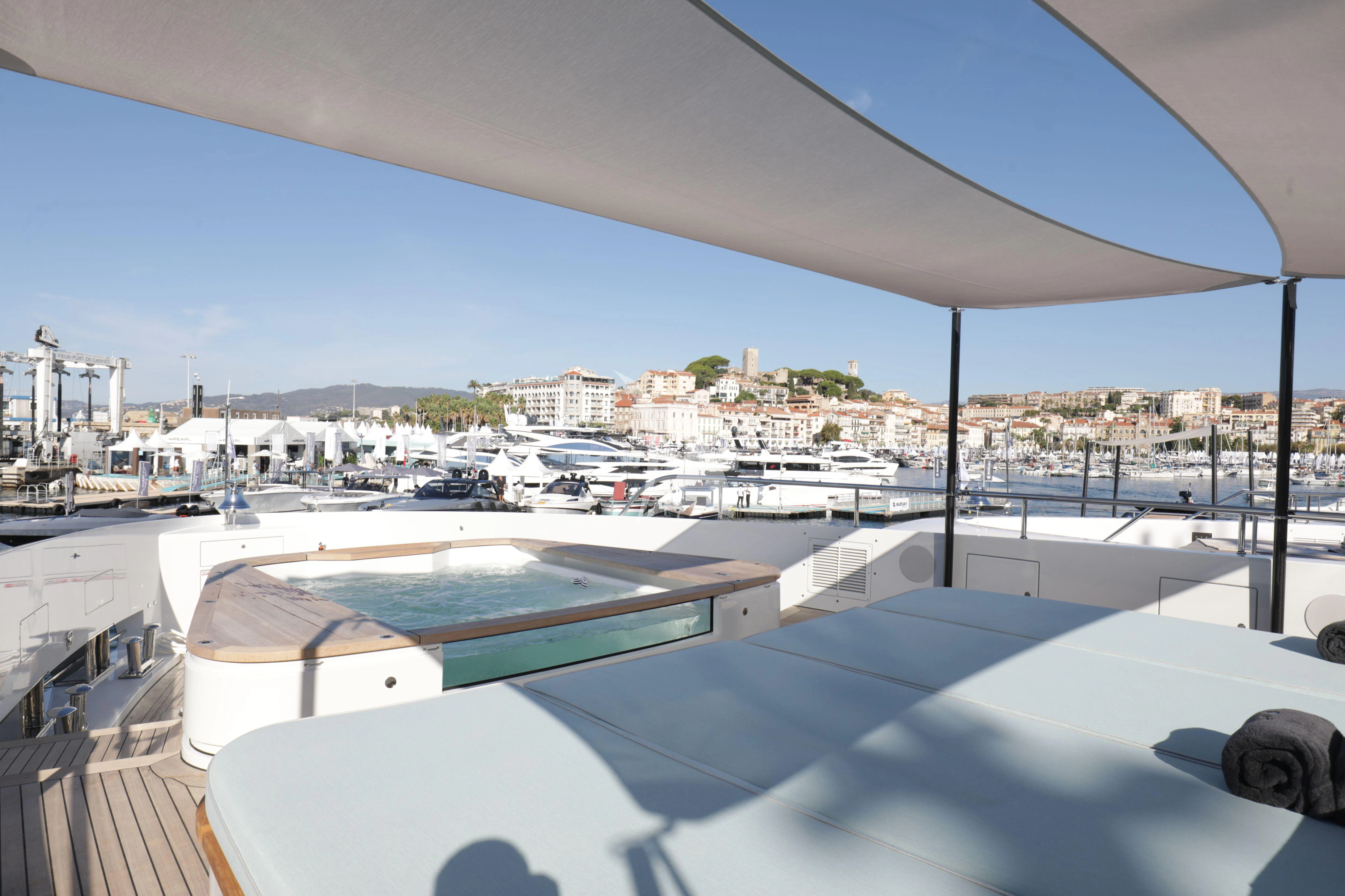 a pool on a deck overlooking a city aboard EH2 Yacht for Sale