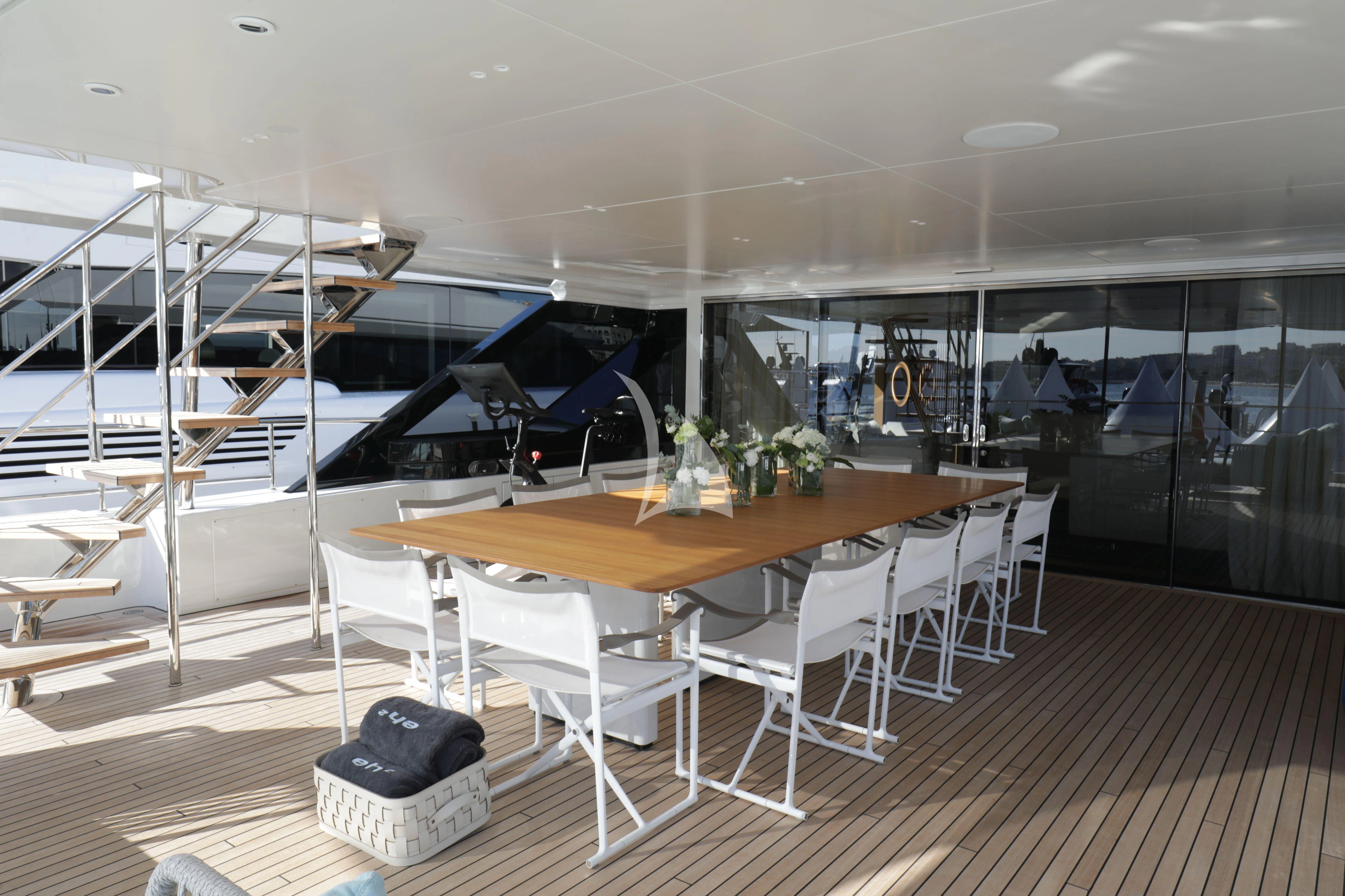 a room with a table and chairs aboard EH2 Yacht for Sale