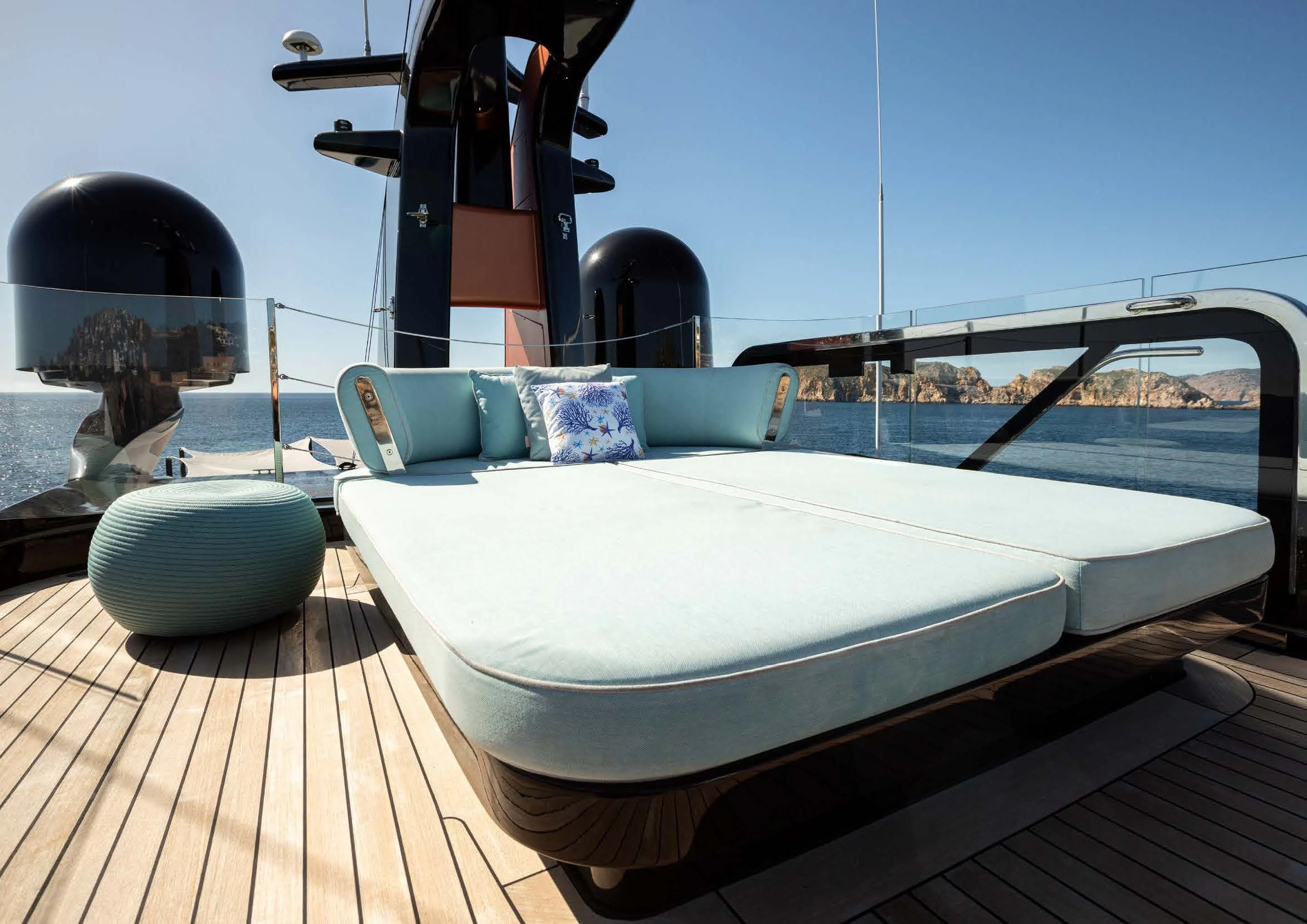 a white bed on a deck aboard EH2 Yacht for Sale