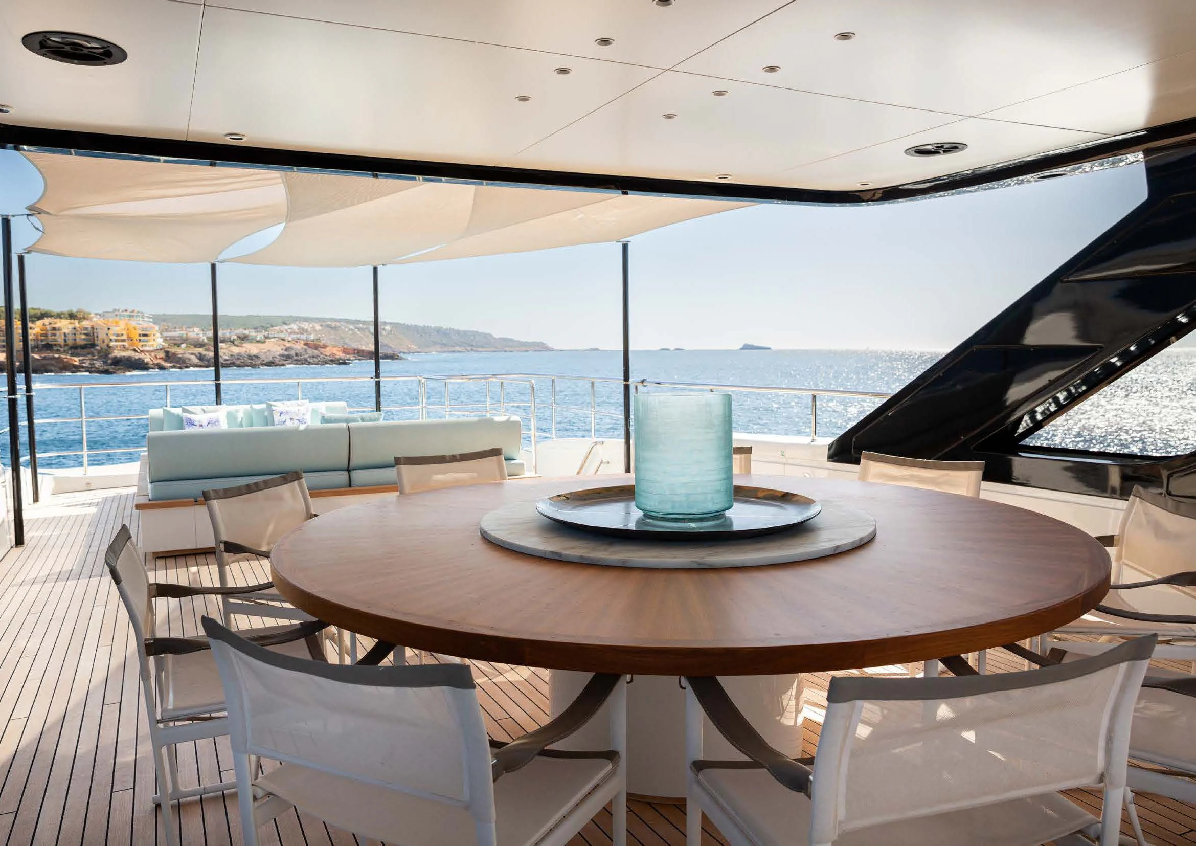a table with chairs on it aboard EH2 Yacht for Sale