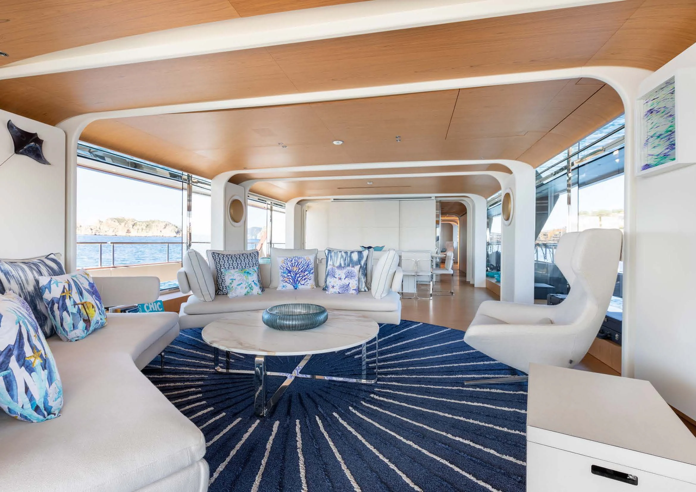 a living room with a large blue rug aboard EH2 Yacht for Sale