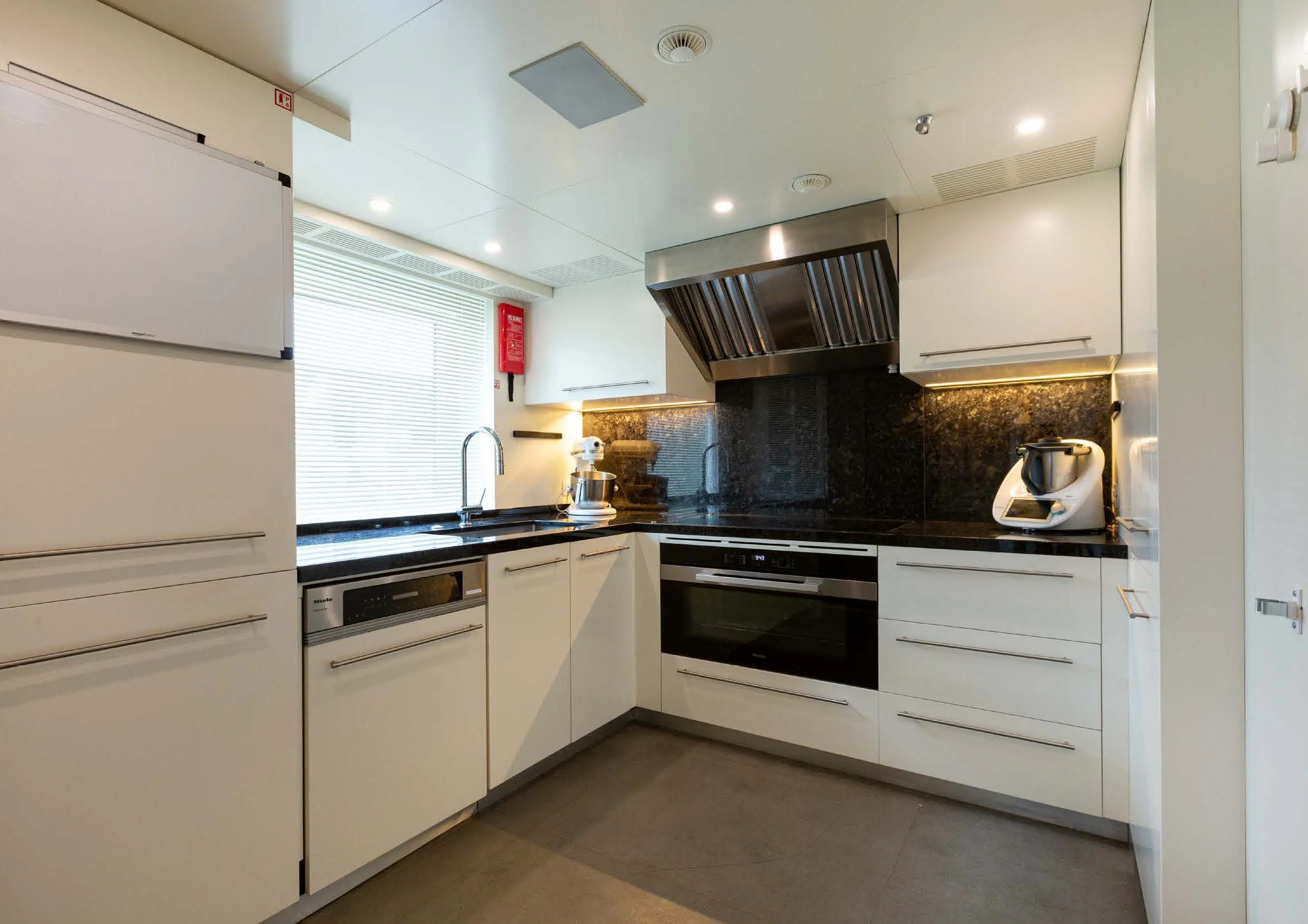 a kitchen with white cabinets aboard EH2 Yacht for Sale