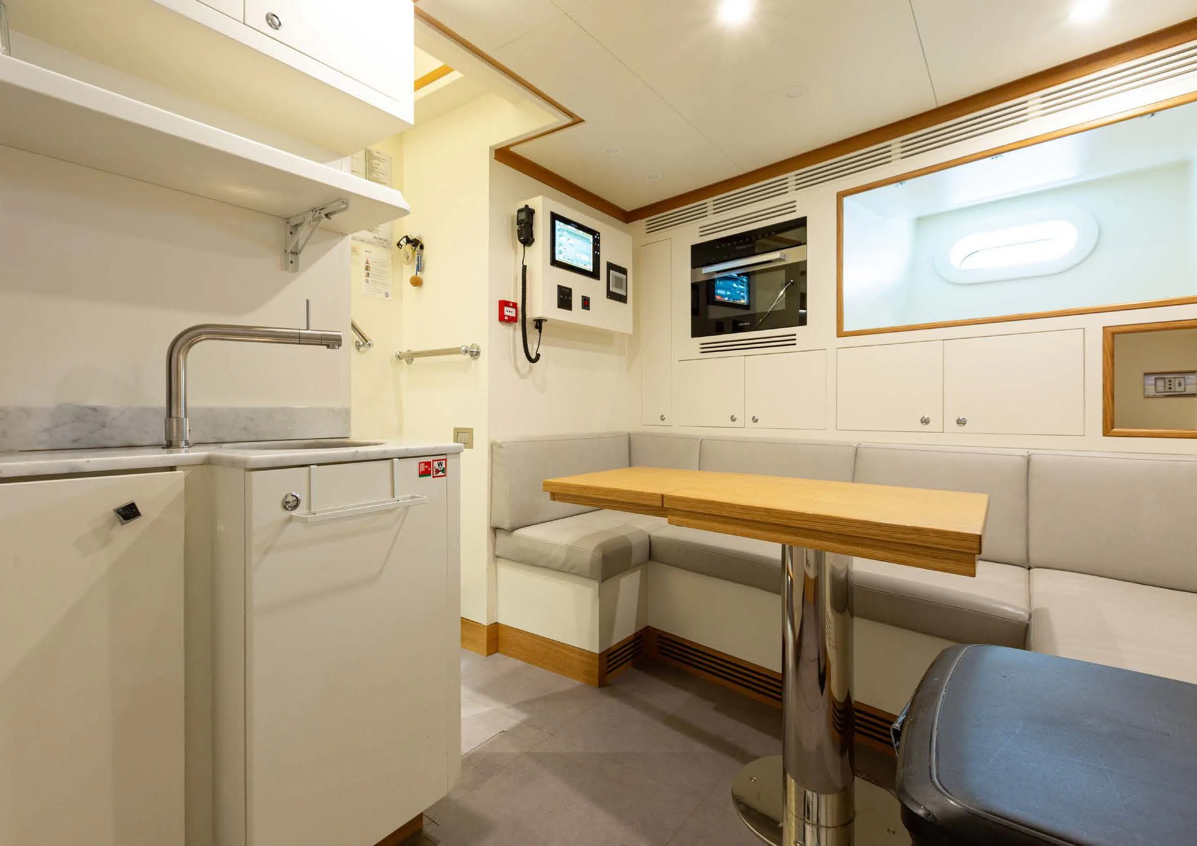 a room with a table and chairs aboard EH2 Yacht for Sale