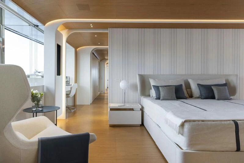 a bedroom with a bed and a table aboard EH2 Yacht for Sale