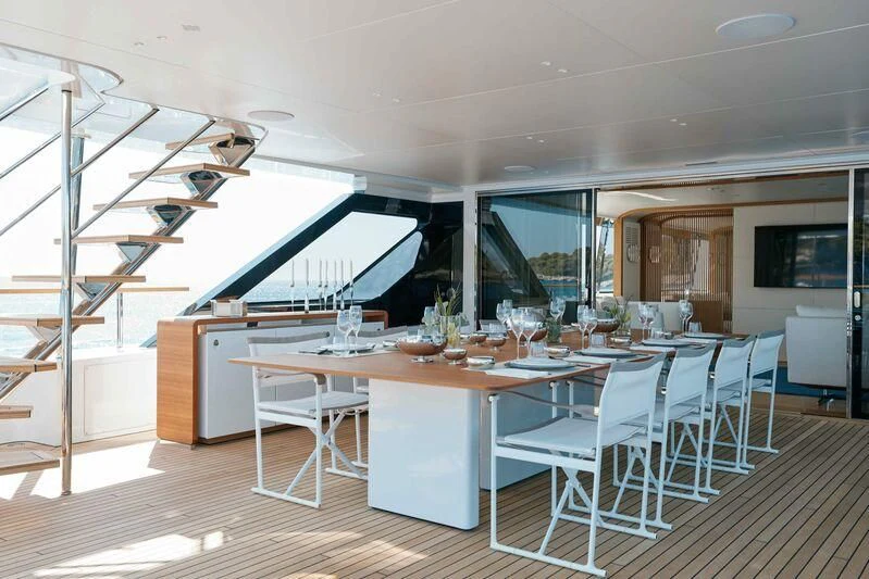 a room with a table and chairs aboard EH2 Yacht for Sale