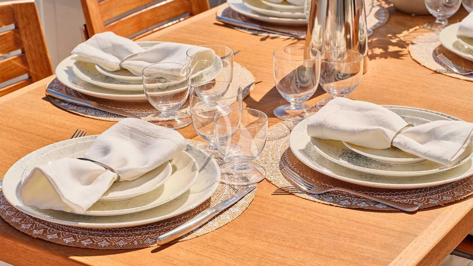 a table with plates and glasses aboard AMICI PER SEMPRE Yacht for Charter