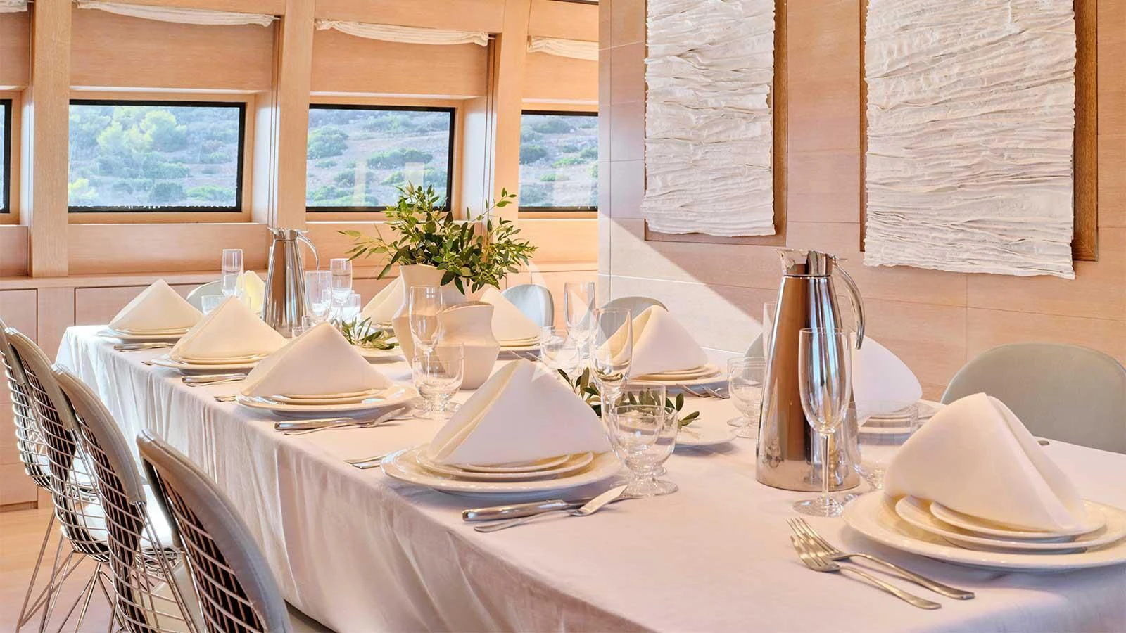 a table with plates and glasses aboard AMICI PER SEMPRE Yacht for Charter