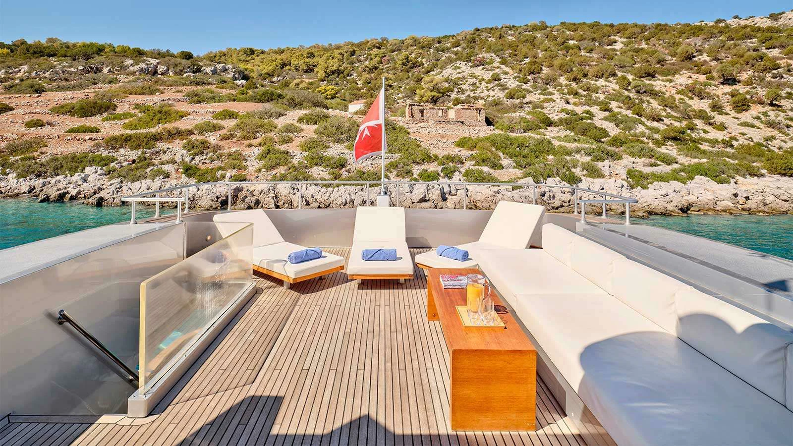 a deck with a view of a city and a body of water aboard AMICI PER SEMPRE Yacht for Charter