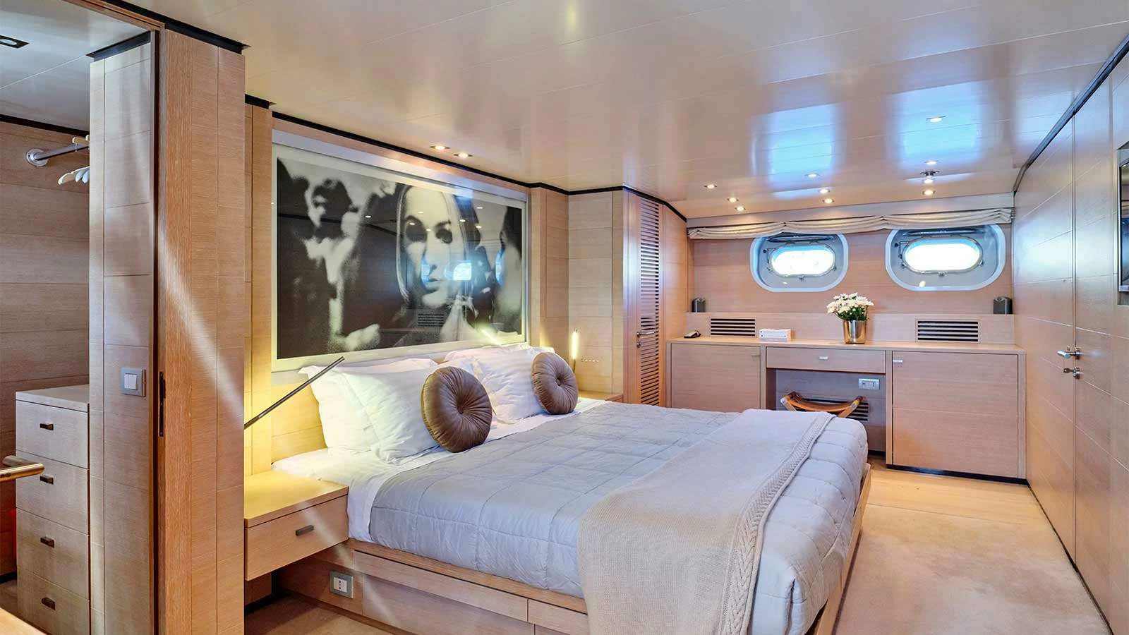 a room with a bed and a painting on the wall aboard AMICI PER SEMPRE Yacht for Charter