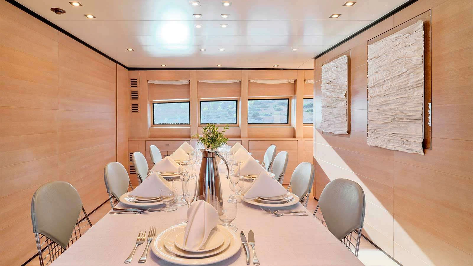 a table with plates and chairs aboard AMICI PER SEMPRE Yacht for Charter