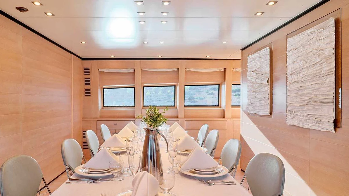 a table with plates and chairs aboard AMICI PER SEMPRE Yacht for Charter