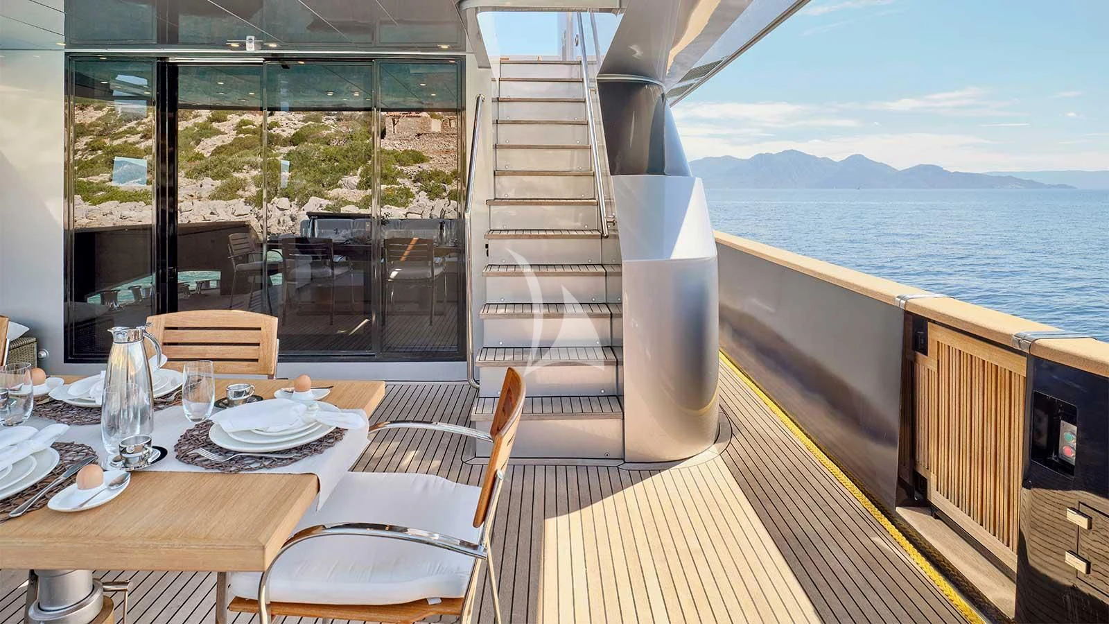 a table with plates and glasses on it aboard AMICI PER SEMPRE Yacht for Charter